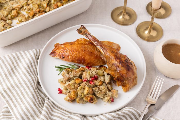 Honey glazed turkey pieces served with stuffing on ceramic plate,
