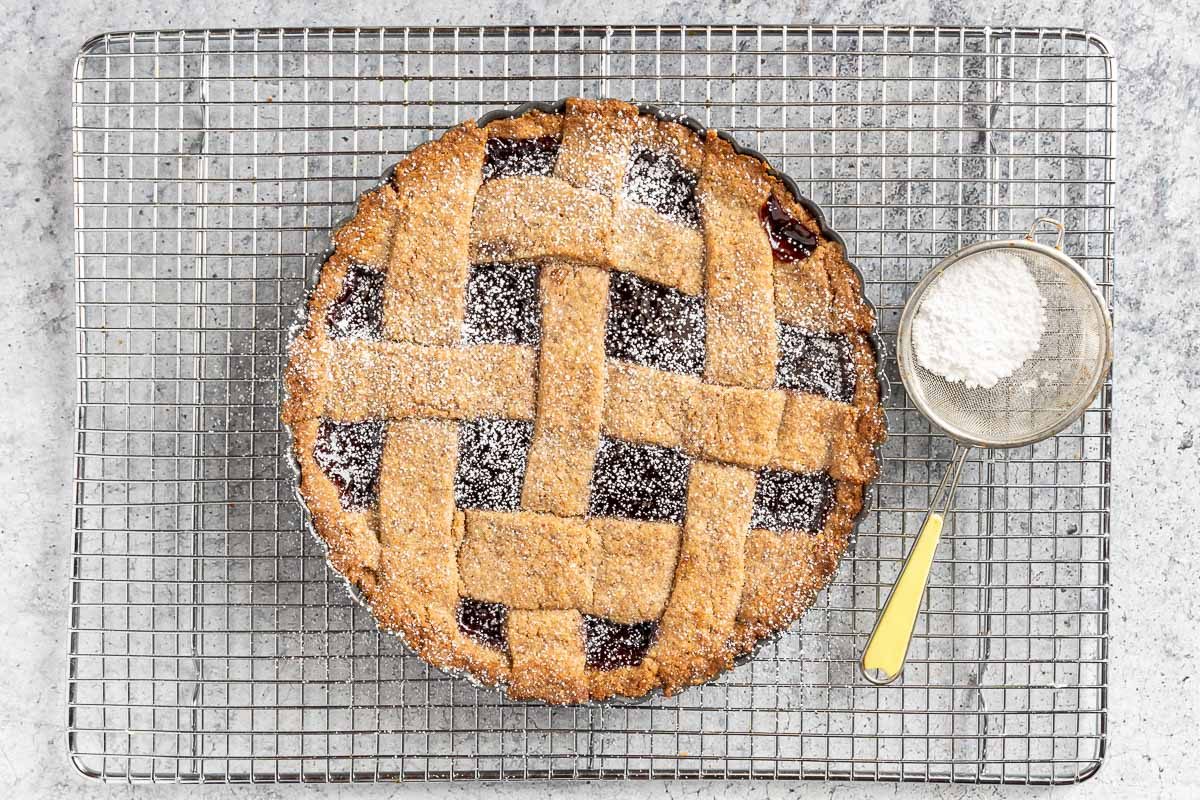 Taste of Home Linzer Torte photo of the baked torte with confectioners sugar.