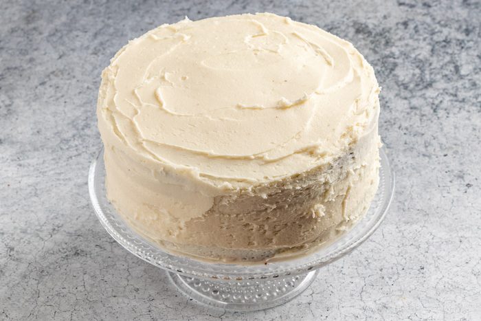 Taste of Home Marble Cake photo of assembling and frosting the cake.