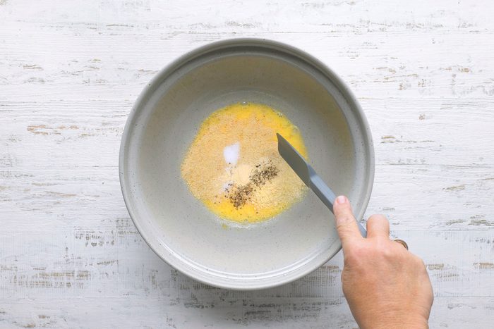 Add the bread crumbs, cheese, salt, pepper and garlic powder and mix it with spatula