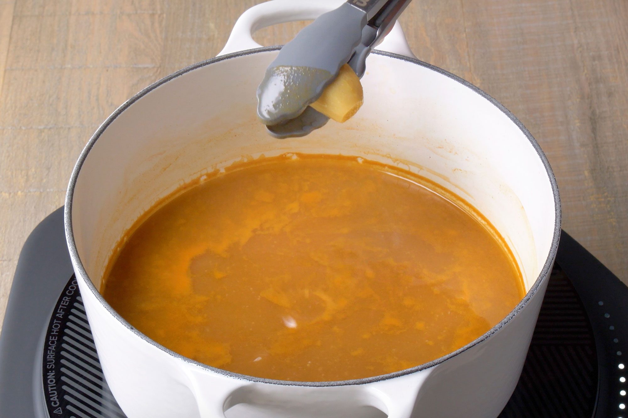 Table view shot of discard ginger; induction; wooden surface;