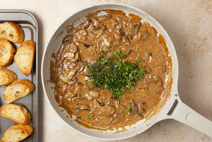 Step 4 of Taste of Home Mushroom Bruschetta is to add the fresh herbs and top the crostini