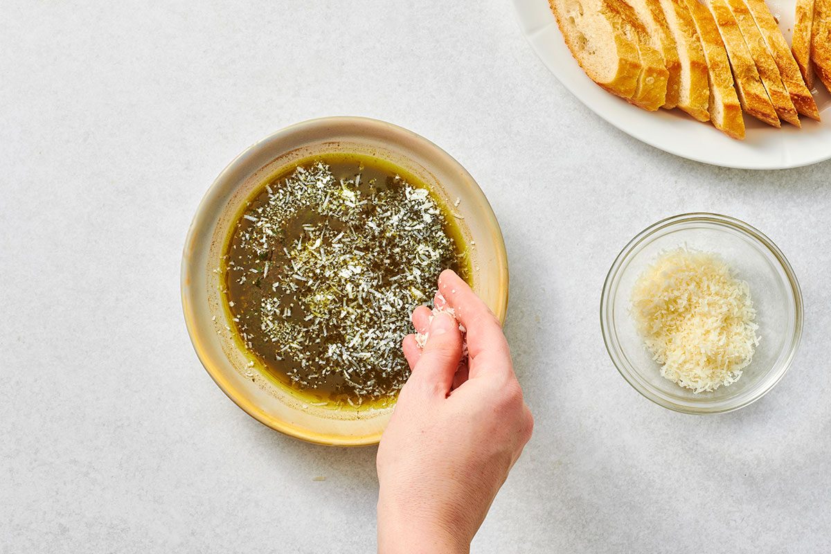 Garnishing dipping oil with cheese 