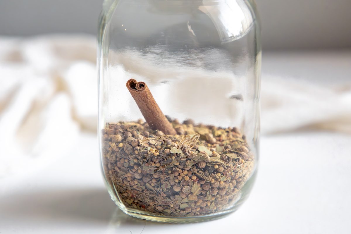Close up beauty shot for Taste of Home Pickling Spice with all ingredients in a mason jar.