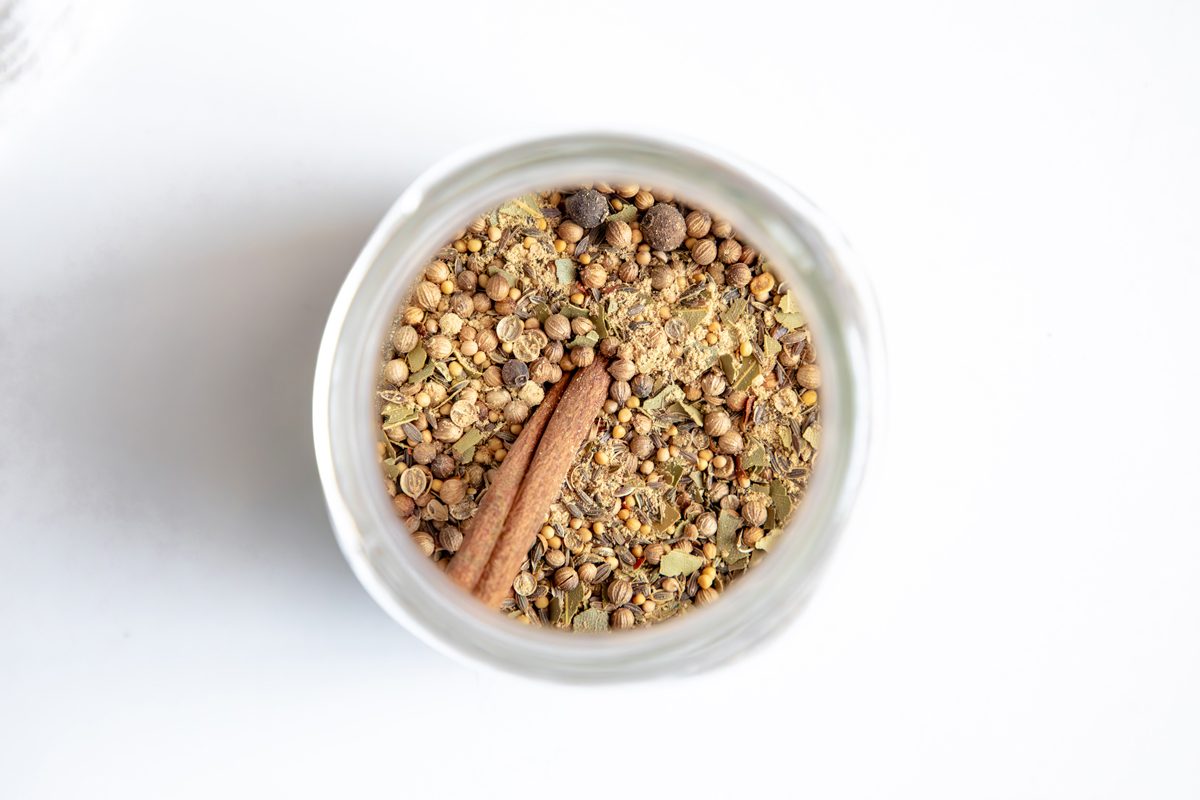 Overhead beauty shot for Taste of Home Pickling Spice with all ingredients in a mason jar.