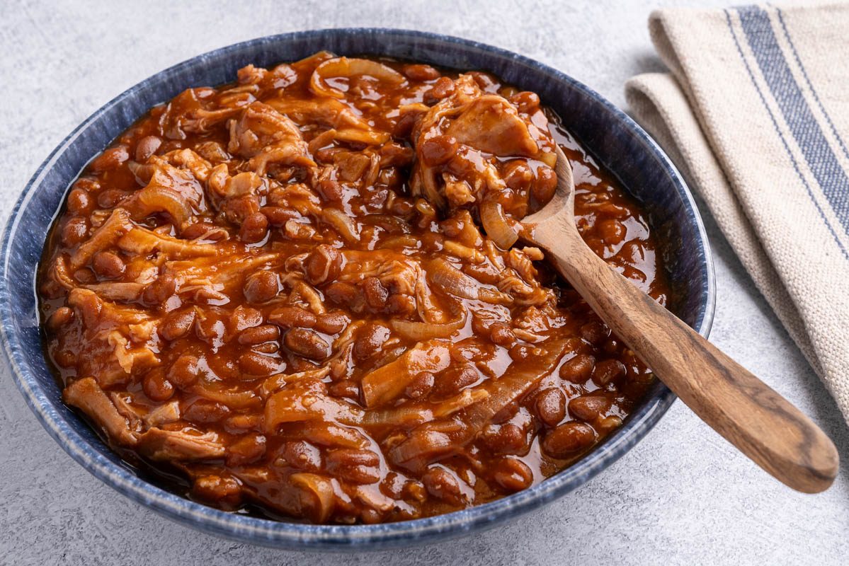 Taste of Home Pork and Beans recipe photo of the finished recipe in a serving bowl.