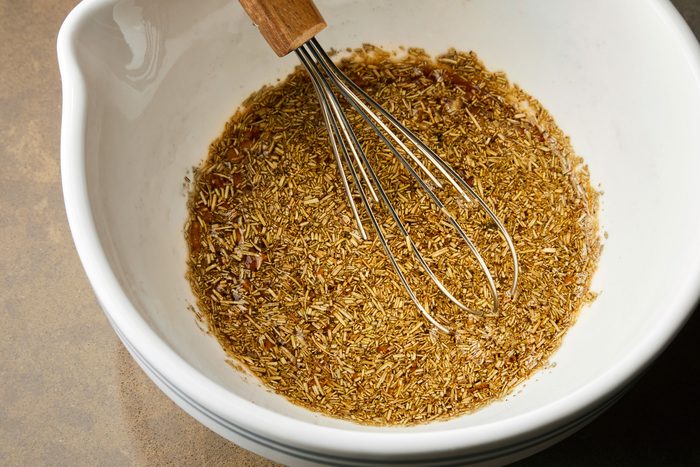 overhead shot of Stiring in a half cup water in dry ingredients with a whisker