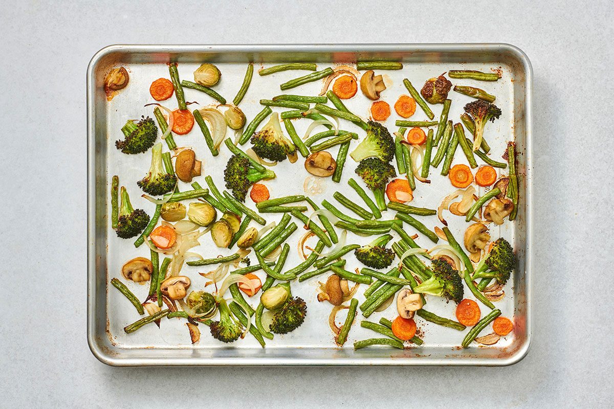 Cooked vegetables on a baking sheet, lightly browned and tender