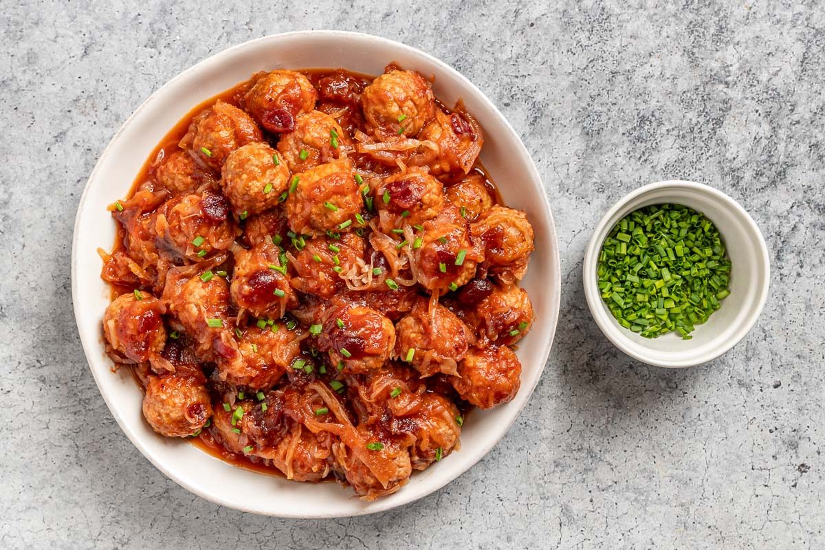 Taste of Home Sauerkraut Meatballs photo of the cooked meatballs topped with chives.