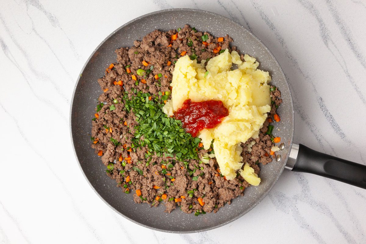 Step 2 of Taste of Home Savory Meat Pie is to cook the beef and carrot and onion; add the rest
