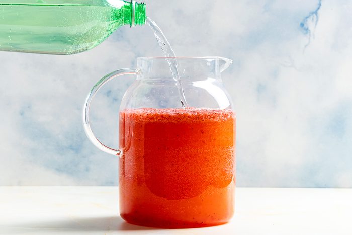 Taste of Home Sprite and Strawberry Drink photo of combining all the ingredients in a pitcher.