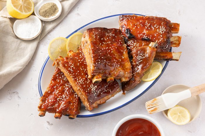 Sweet and sour spareribs ready, served on enamel plate.