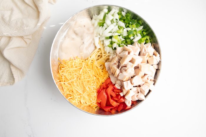 Overhead shot for Taste of Home Turkey Tetrazzini with Cream of Mushroom Soup, ingredients in a large bowl before being mixed.