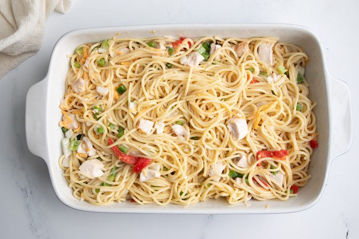 Overhead shot for Taste of Home Turkey Tetrazzini with Cream of Mushroom Soup, ingredients in a large baking dish.