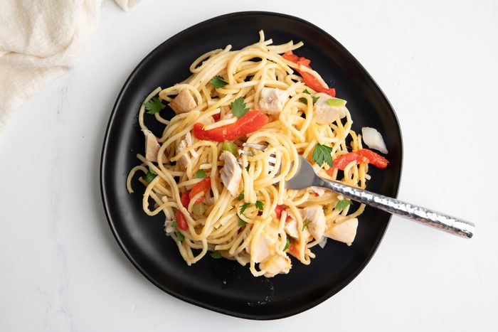 Overhead shot for Taste of Home Turkey Tetrazzini with Cream of Mushroom Soup, being served on a black plate.