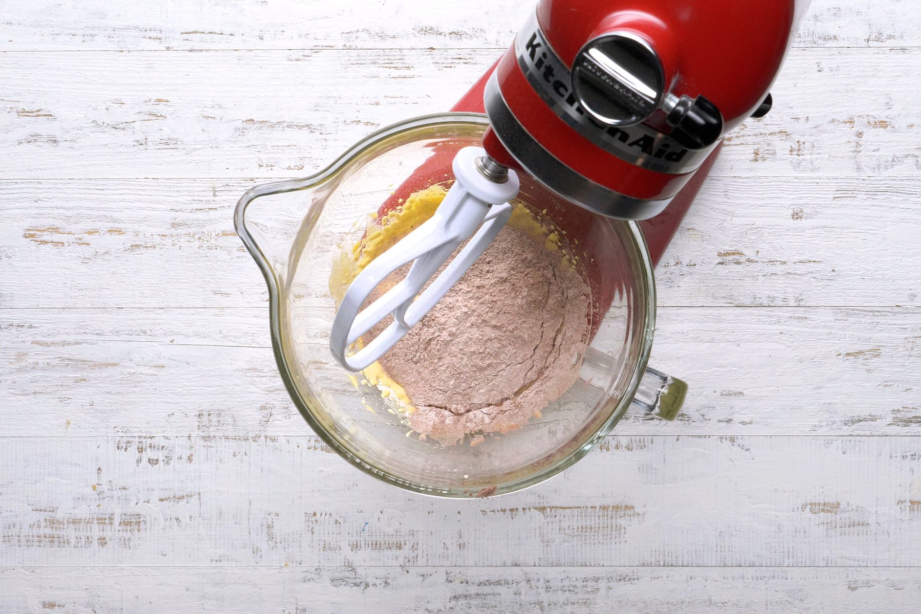 Gradually adding 1/3 cup sugar to the beaten egg yolks. Sifting flour, baking cocoa, and baking powder together.