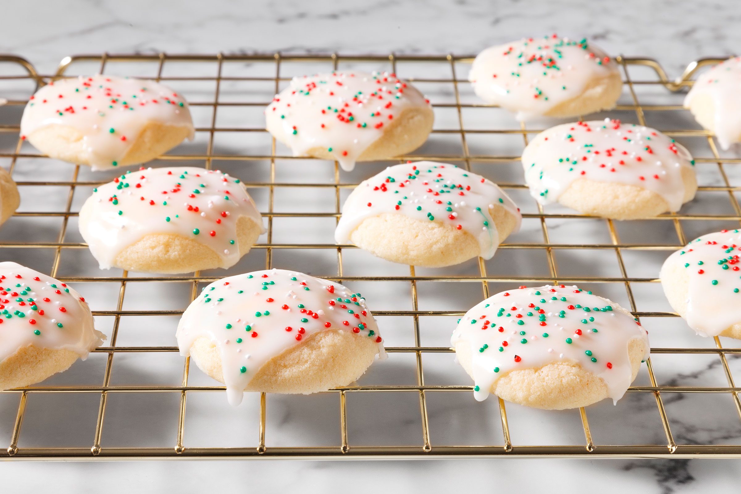 Anise Cookies on a wire rack with sprinkles on it