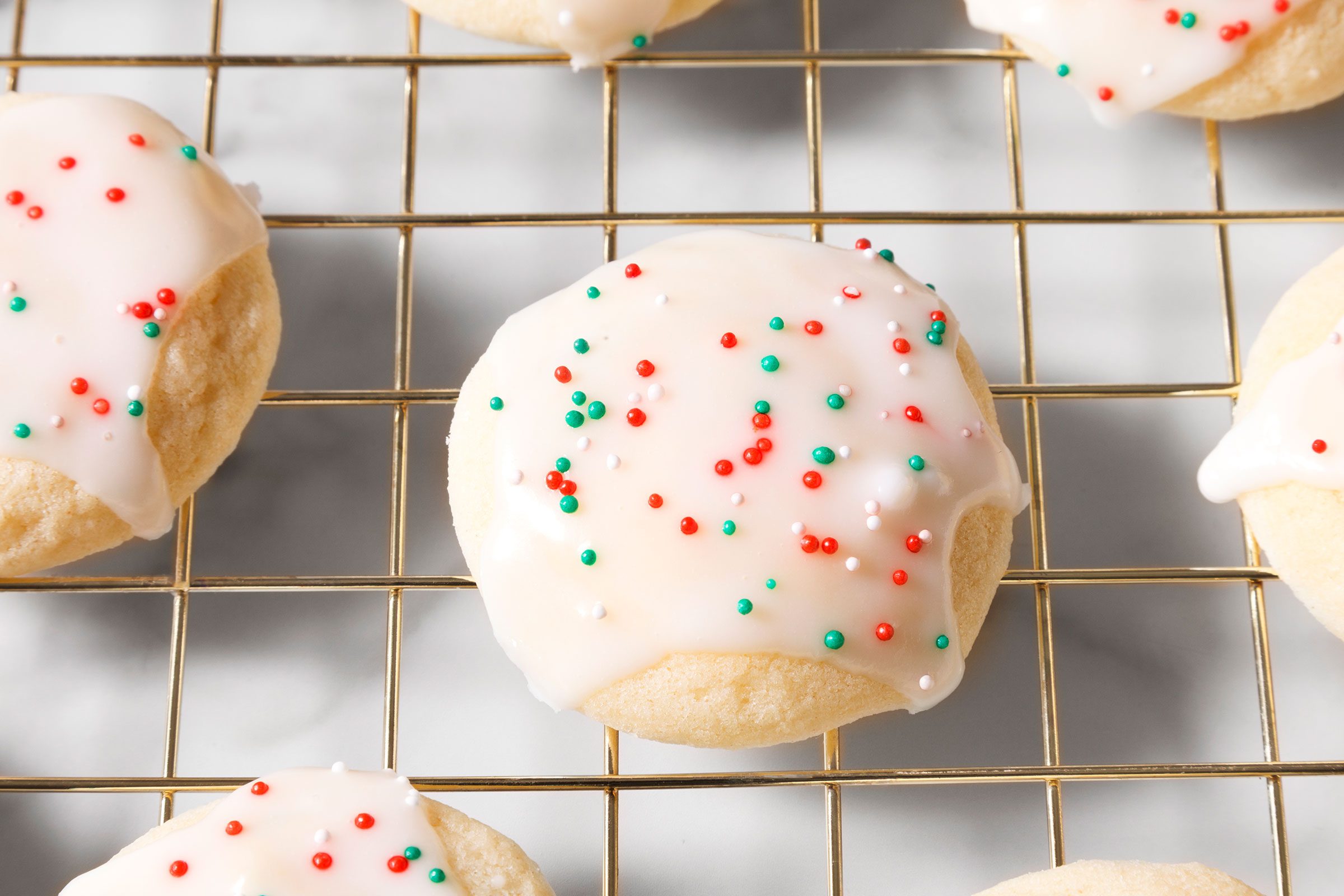 Anise Cookies on wire rack with sprinkles on it