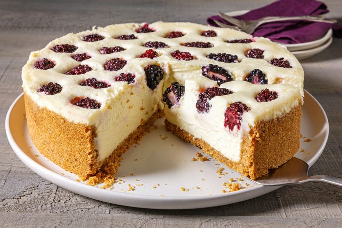 Blackberry Cheesecake whole with a huge slice removed