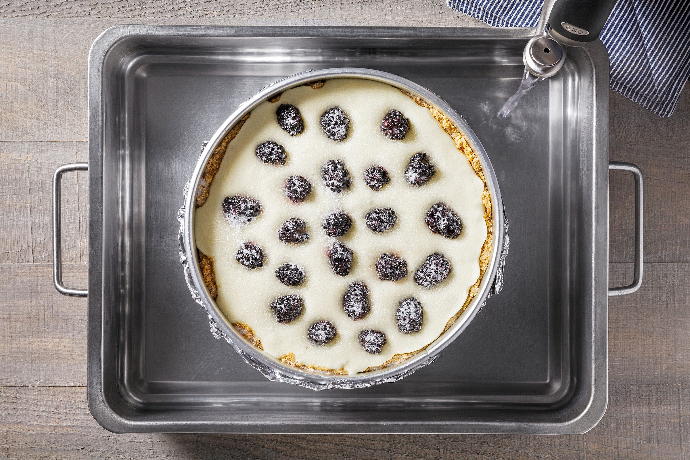 Springform pan placed in a large pan with water filled in it 