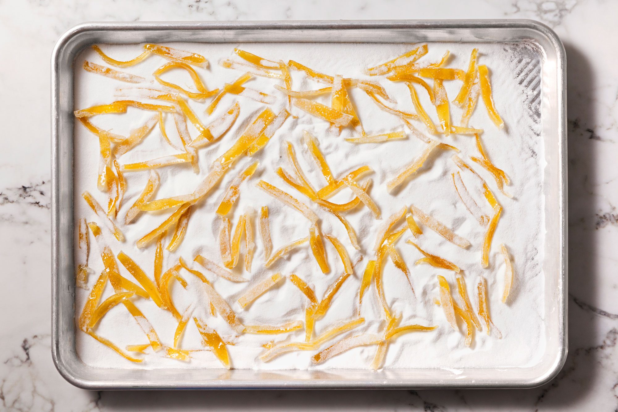Sprinkle superfine sugar into an ungreased baking sheet.