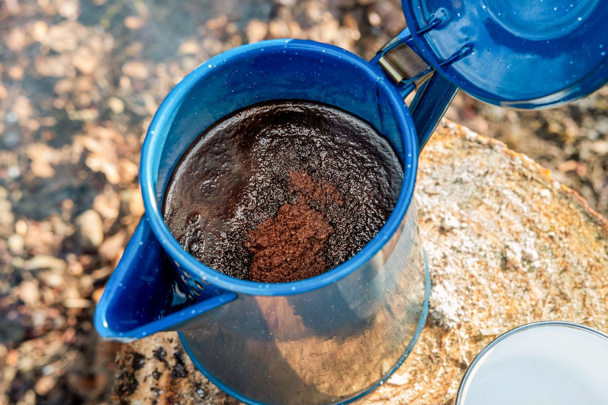 Cowboy coffee made outdoors over wood fire