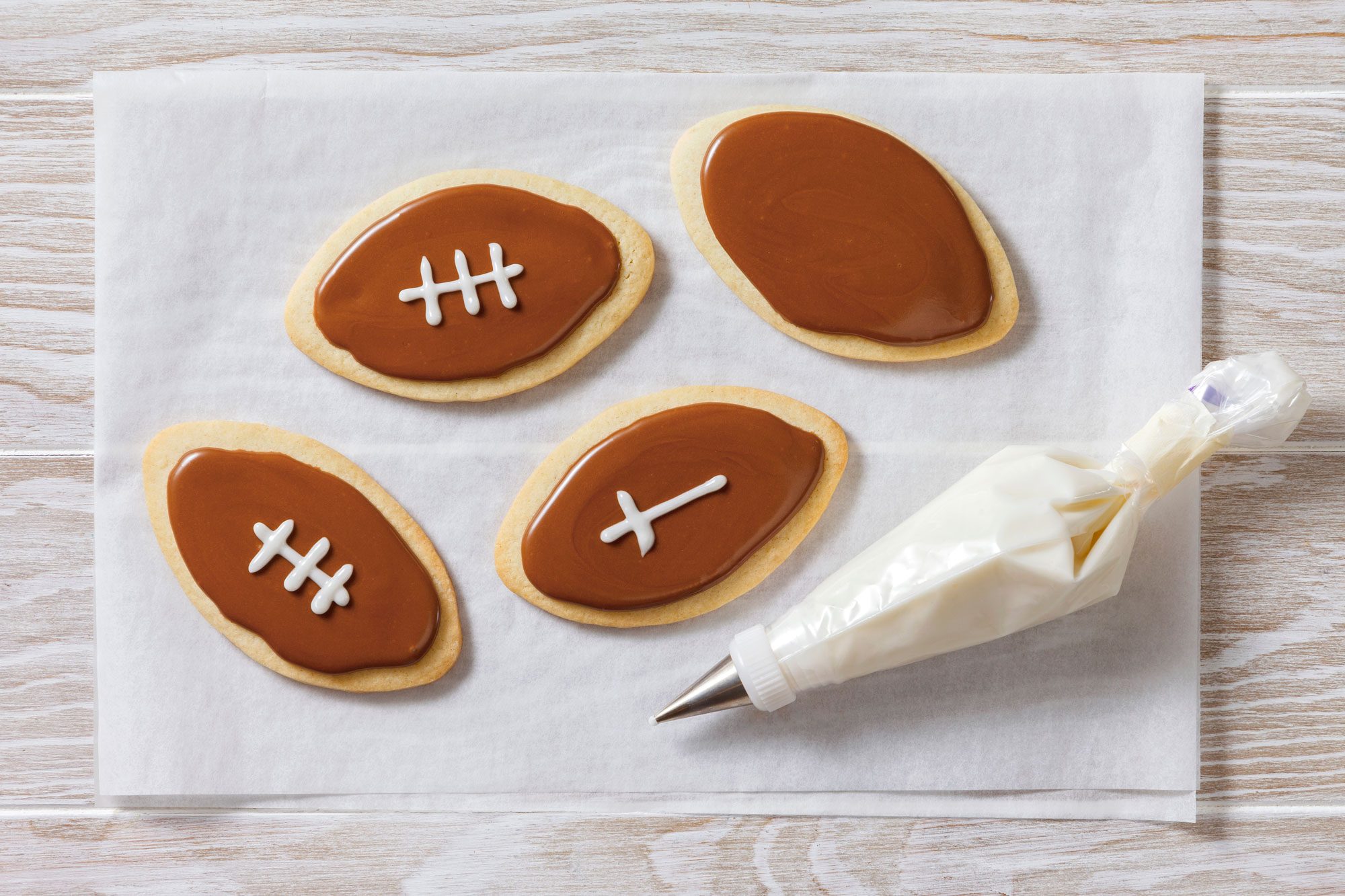 Place white icing in a piping bag fitted with a narrow tip