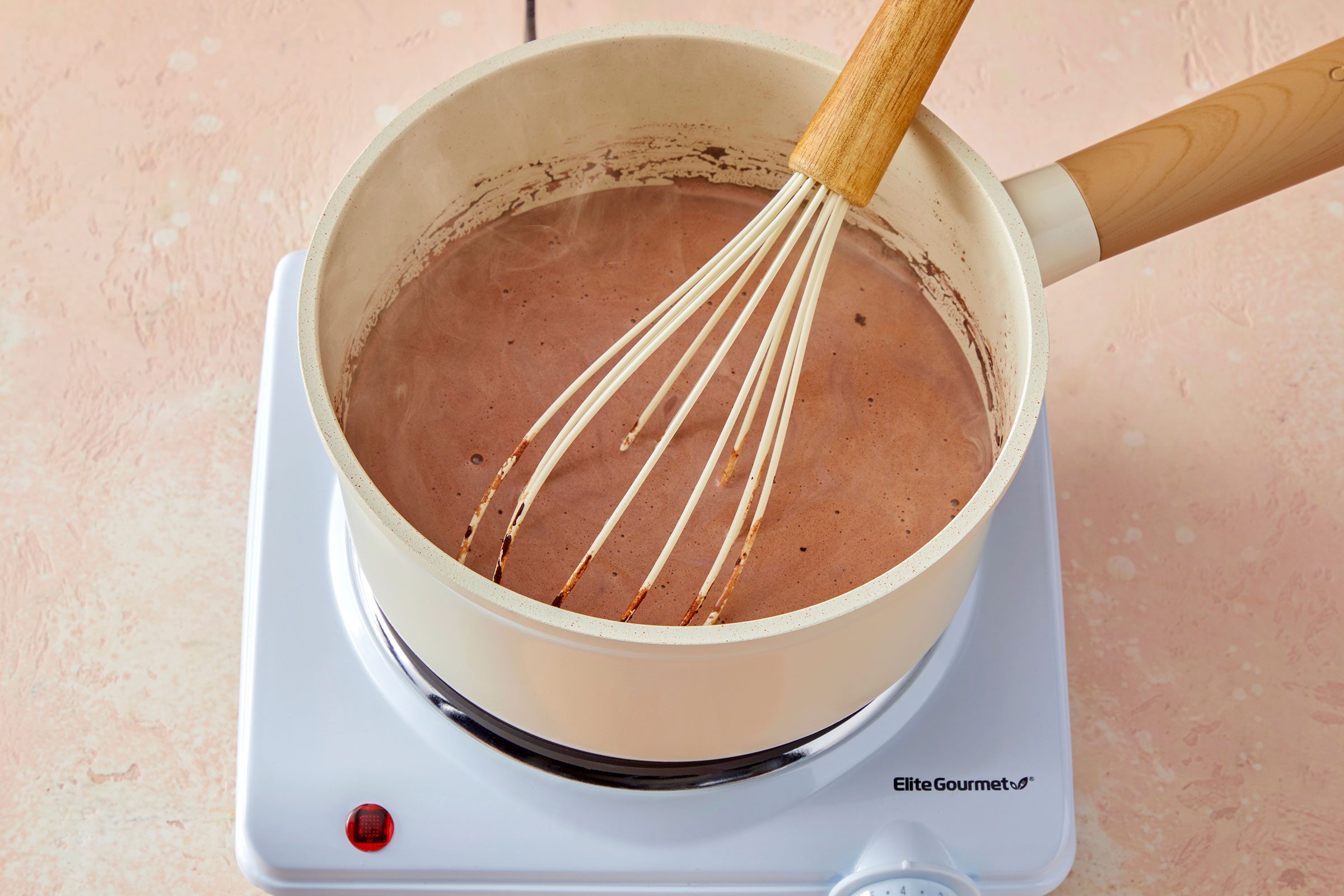 Milk, sugar and cocoa powder brought to simmer in a pan