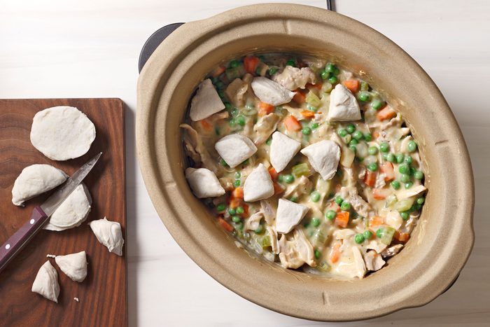 Biscuit pieces cut and placed on top of cooked vegetables. and chicken mixture