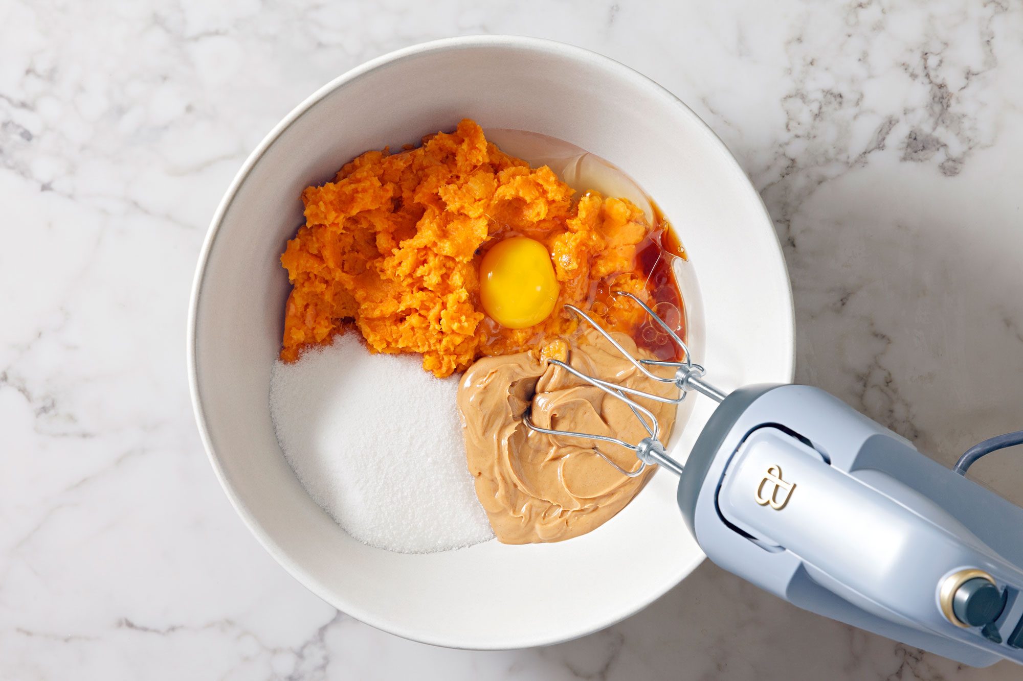 In a large bowl, beat sweet potato puree, sugar, peanut butter, oil, egg