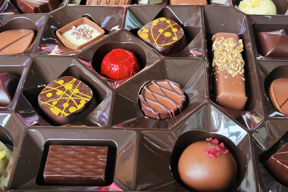 Assorted Belgian chocolates in a brown chocolate truffle box