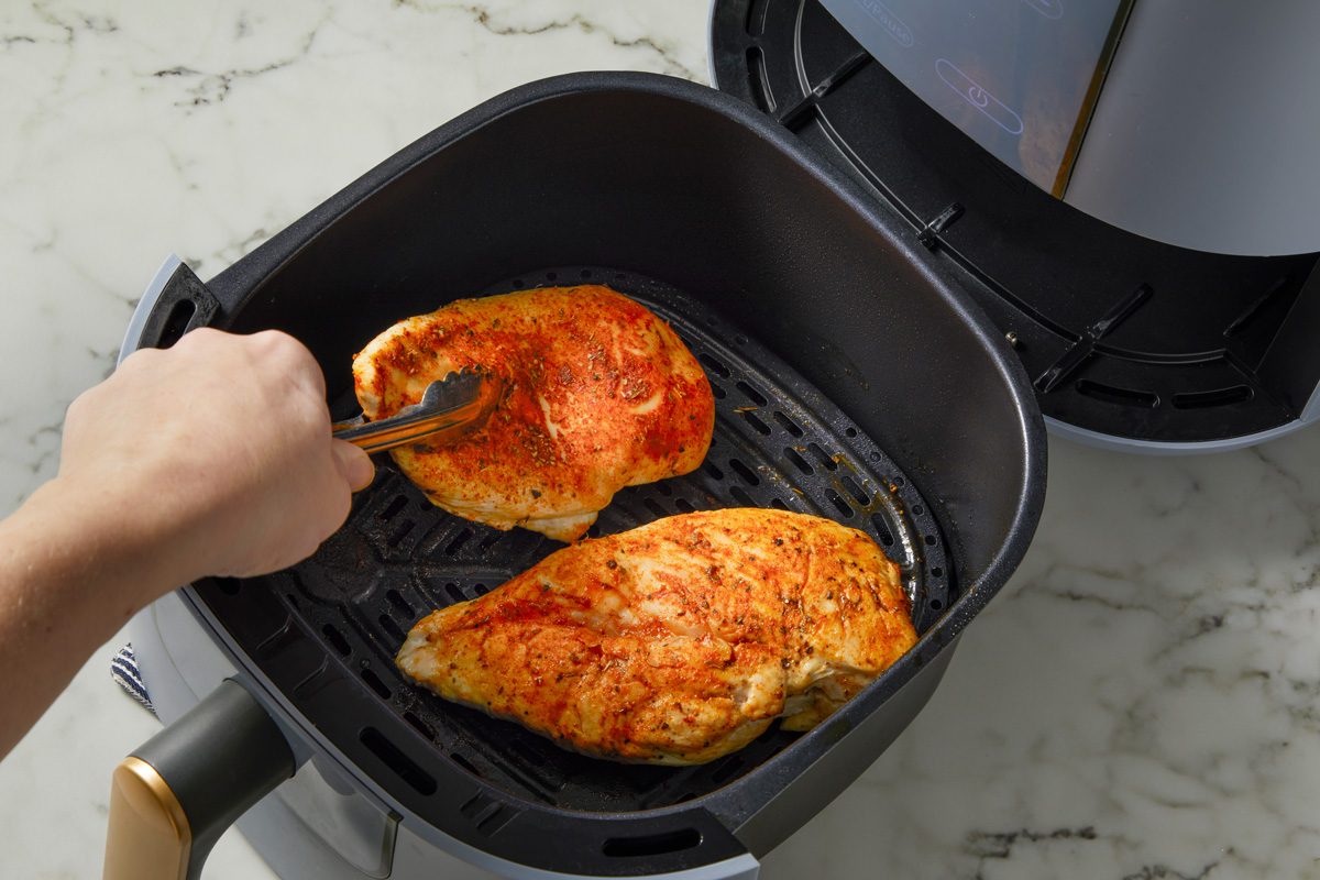 Cooking and flipping chicken breasts in air fryer