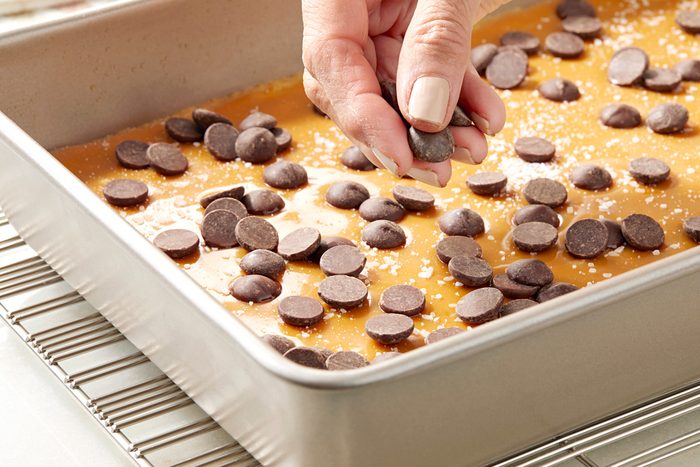 salt and chocolate chips being sprinkled