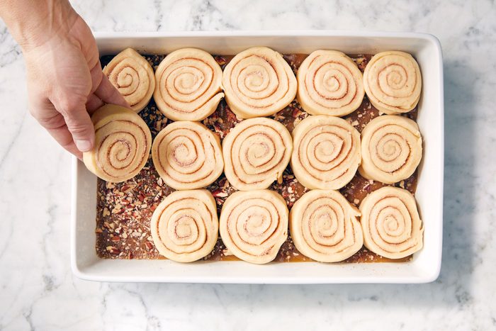 Log of dough cut into pieces and placed on caramel sauce in a dish