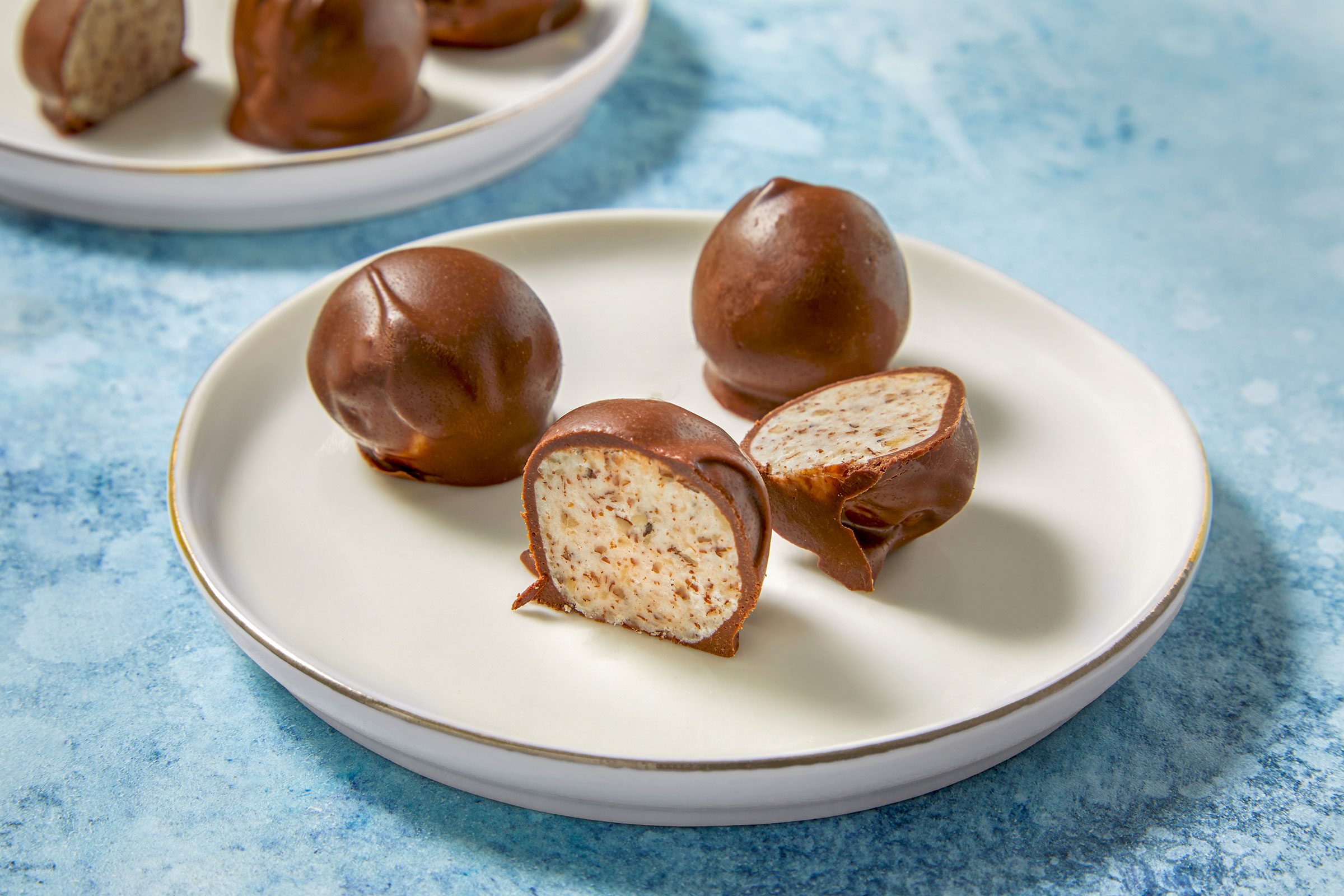 Chocolate Bonbons full and half on a white plate