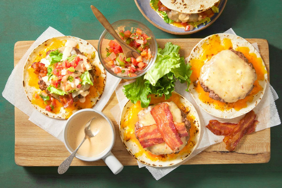 Top half the tortillas with burgers, bacon, lettuce, ranch dressing and pico de gallo; top with remaining tortillas, cheese side down.
