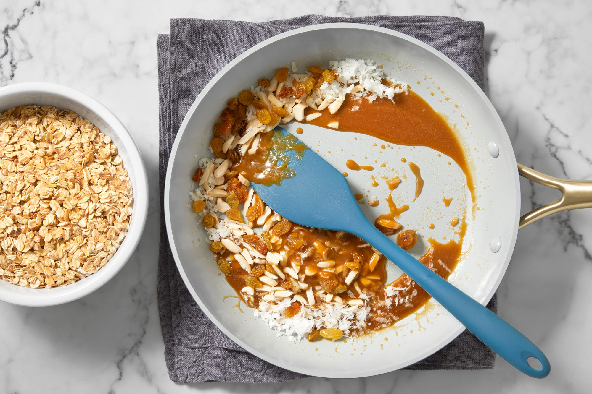 Stir in almonds, raisins, coconut and oats until coated