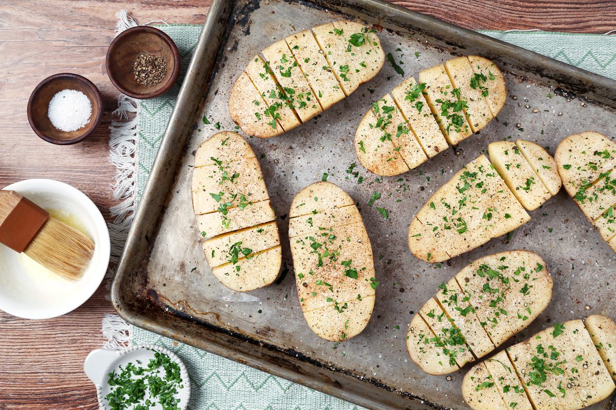 potatoes in a shallow baking dish sprinkled with paprika, parsley, salt and pepper