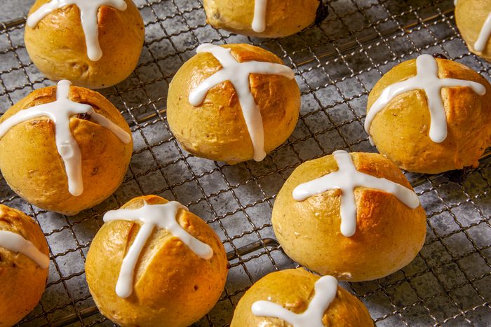 3/4th closeup shot of Traditional Hot Cross Buns; the buns are on a wire rack