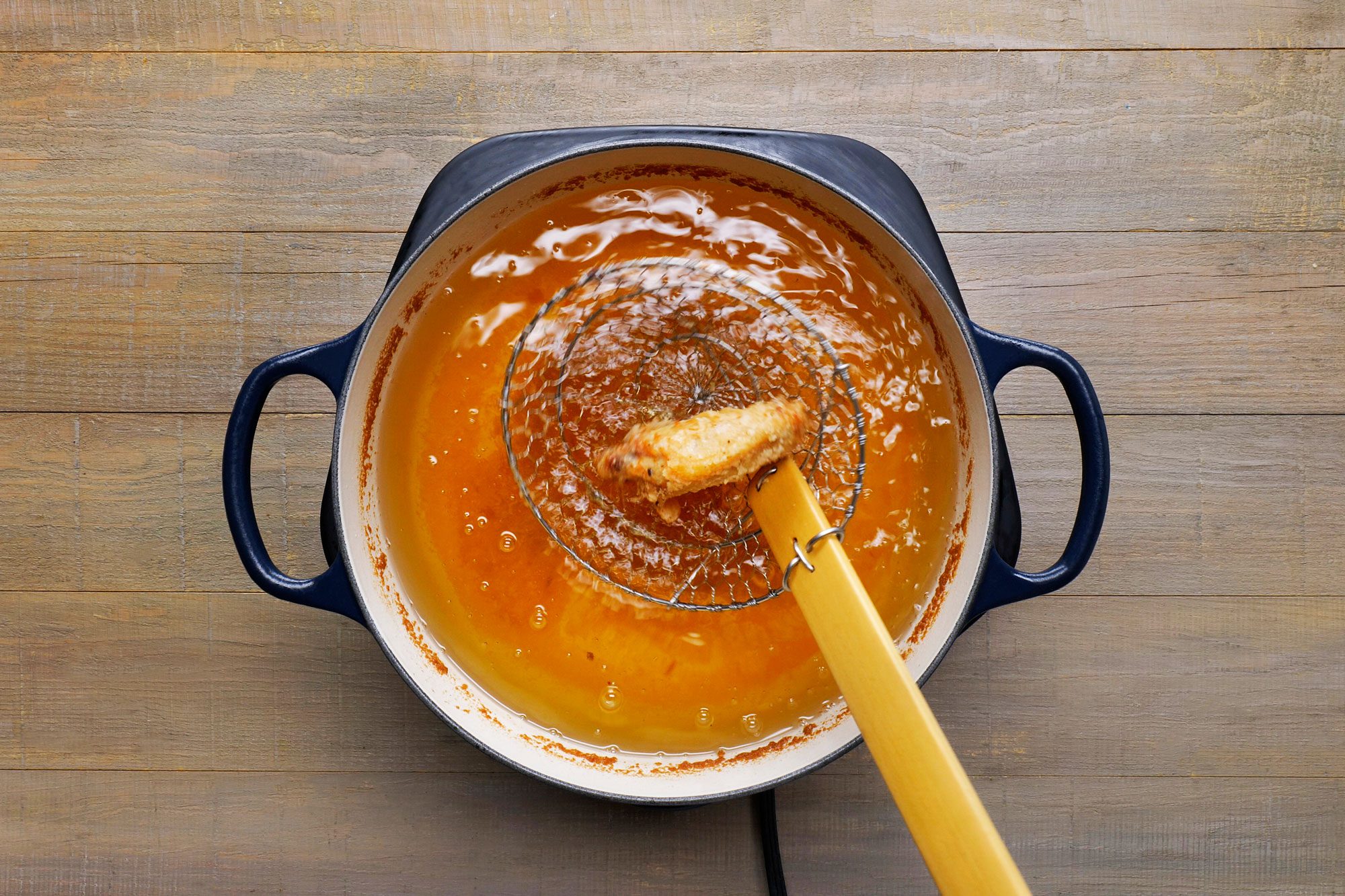Taking out the deep fried chicken from the pan