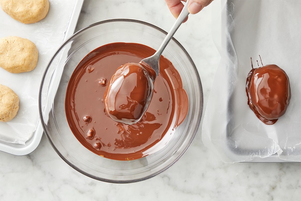 In a microwave, melt chocolate chips and shortening; stir until smooth. Dip eggs in chocolate mixture; allow excess to drip off. Return eggs to baking sheets.