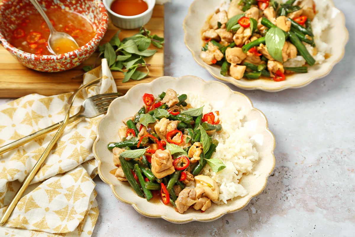 Thai basil chicken served on a plate with jasmine rice.