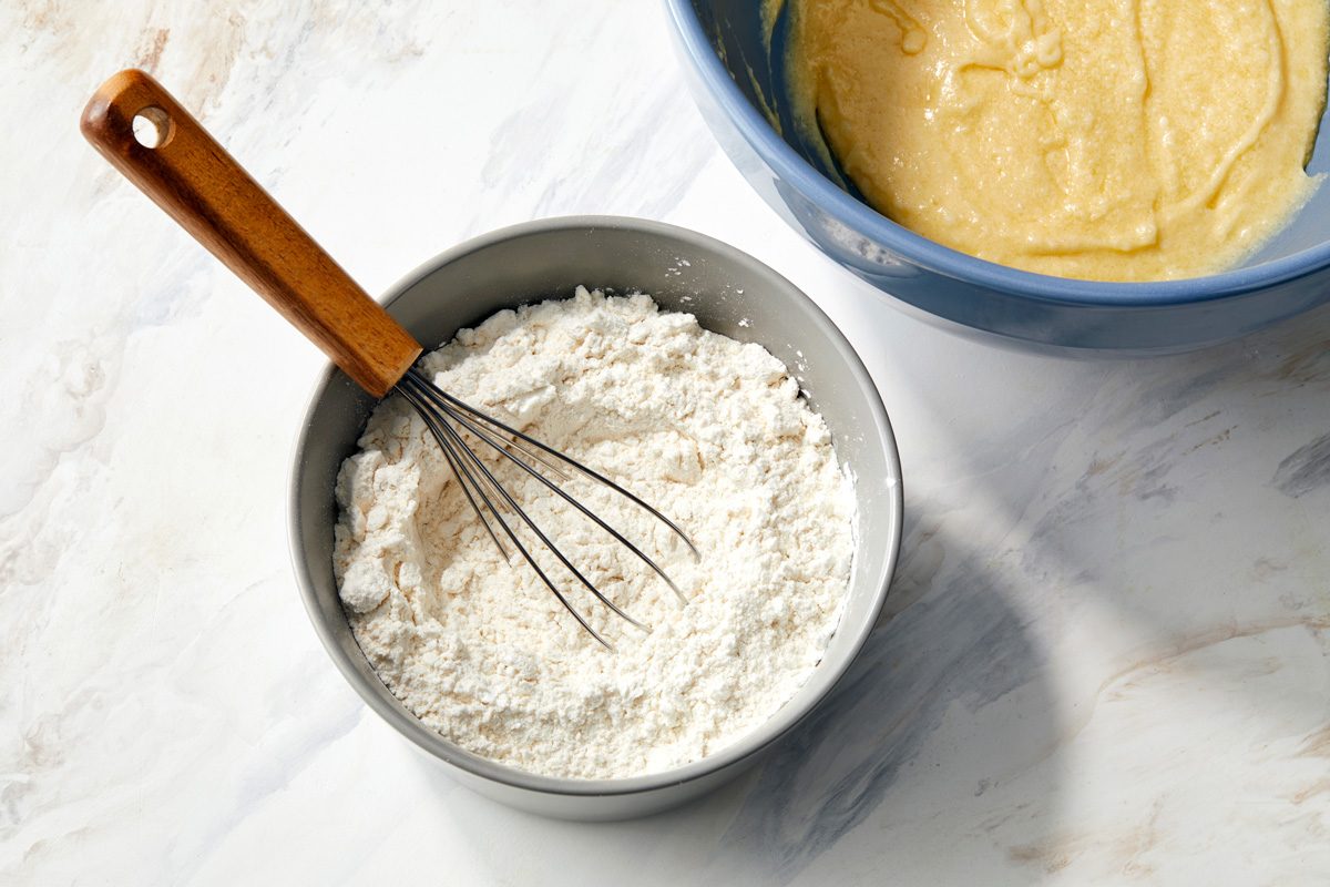 flour, cornstarch, baking powder and salt whisked together in a bowl next to butter mixture