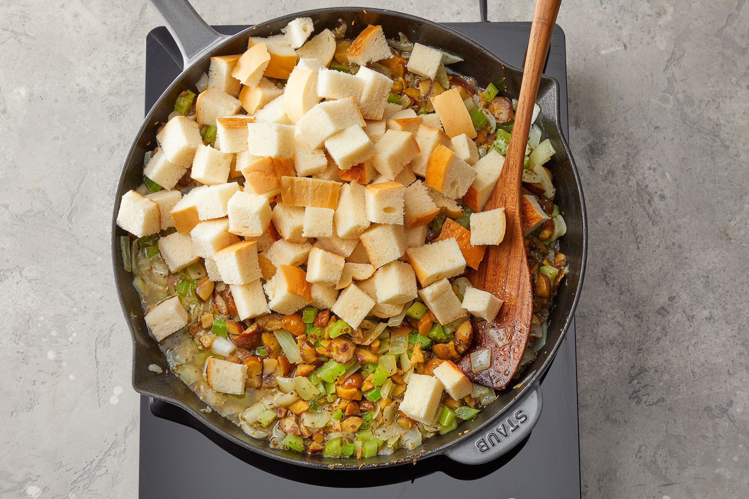 Bread cubes added on the cooked mixture of onion, celery and chestnut