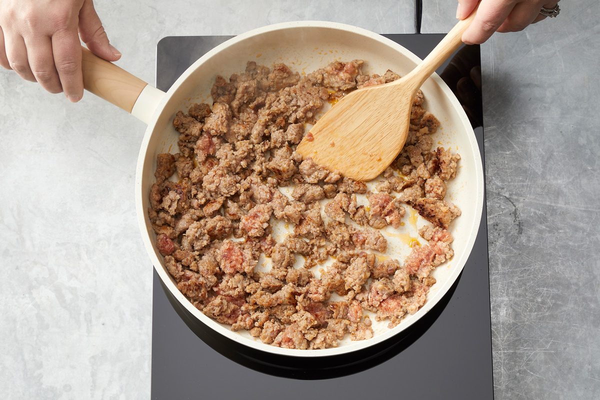 Overhead shot of remove with slotted spoon; drain on paper towels; Drain and discard fat; marble surface