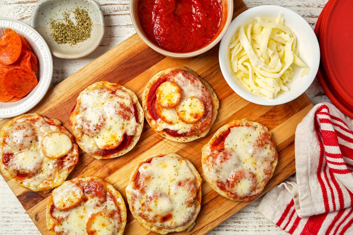 English Muffin Pizzas shot on a white wooden surface; overhead