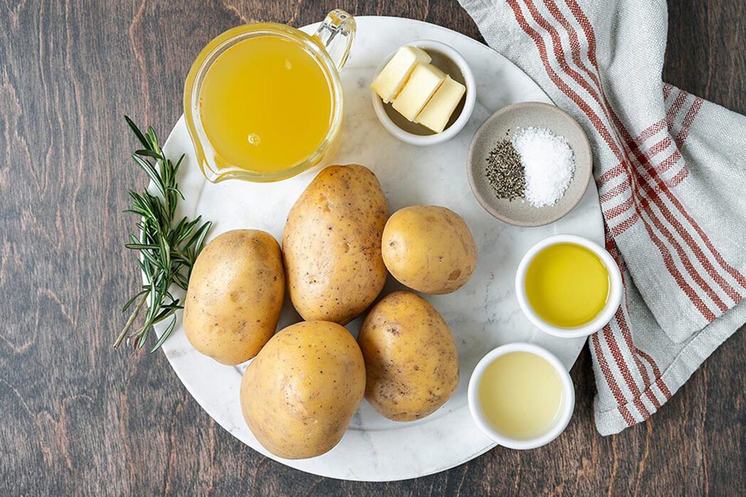 potatoes, Butter, Spices, oil, Lemon Juice, Rosemary kept on a plate