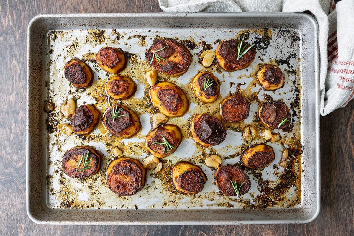 Fully roasted potatoes placed on a baking tray