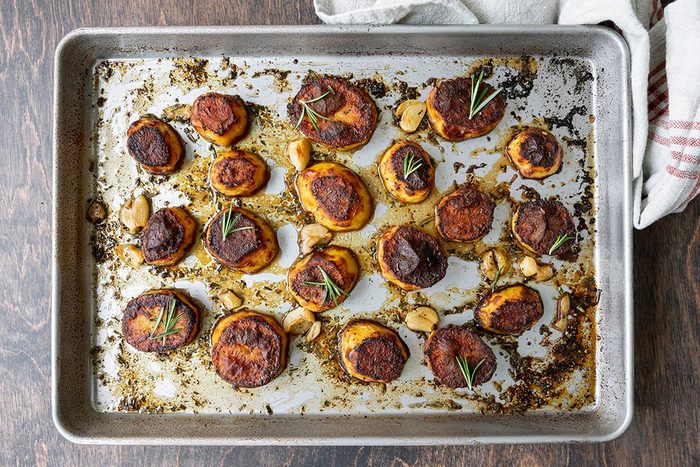 Fully roasted potatoes placed on a baking tray