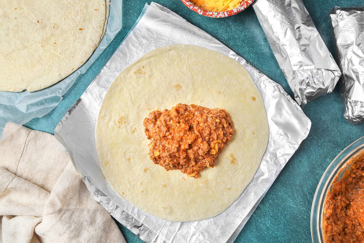 beef and bean mixture at the center of tortilla